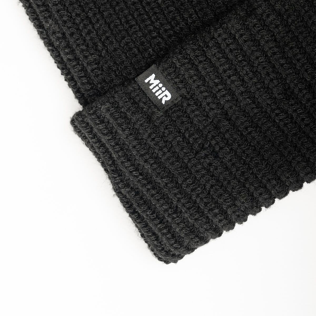 recycled-poly-rib-beanie-h1 WebPDP-RecycledPolyRibBeanie_Studio_TagDetail_Black__BNE002002OS.jpg